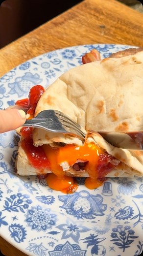 7.8K views · 72 reactions | The Dishoom Bacon Naan Roll has something of a cult following; it must surely be our signature breakfast dish. Each naan is freshly baked – by hand, and to order – in the tandoor. It is then graced with a little cream cheese, tomato-chilli jam and fresh coriander leaves, and wrapped around one of our first-rate fillings. | Dishoom | Facebook