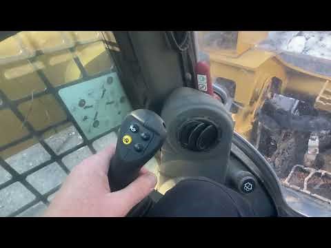 Operator controls on a Caterpillar 299D3 track loader.