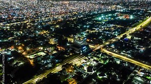 Aerial time-lapse view of traffic at night in Accra, Ghana with drone push in