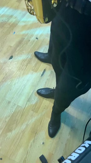 Brass Saxophone Performance at Social Gathering