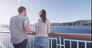 New Zealand travel people enjoying nature view of ferry boat cruise in Marlborough Sounds trip from Picton to Wellington, Cook strait crossing. Couple tourists watching sunset vacation.
