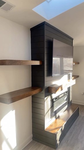 Custom Electric fireplace with a hidden drawer and floating shelves.…. • • • #mantel #manteldecor #shelf #floatingshelves #tvframe #tvframediy #frame #diy #diyfireplace #electricfireplace #diyinspiration #carpentry #carpenter #builder #woodworking #woodworker #framer #shiplap #buildsomething #finewoodworking #bench #wood #featurewall #beforeandafter #woodart #woodartist #woodshop #handmade #woodshop #floatingshelves #shelves | Avwooddesigns