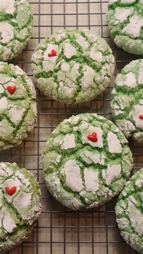 Day 7 of my 12 Days of Dollar Tree Christmas Desserts 🎄✨ Today we’re making Grinch Cookies using a simple cake mix base. These are soft, chewy, crinkle-style cookies colored bright green and finished with piped red hearts. Festive, fun, and perfect for holiday cookie trays. INGREDIENTS: • 1 box white cake mix • 2 eggs or ½ cup unsweetened applesauce • Just under ½ cup oil (7 tablespoons) • Green food coloring • Powdered sugar DIY COOKIE ICING: • Powdered sugar • Water • Red food coloring INSTRU