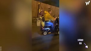 Woman in mobility scooter drags dog along road
