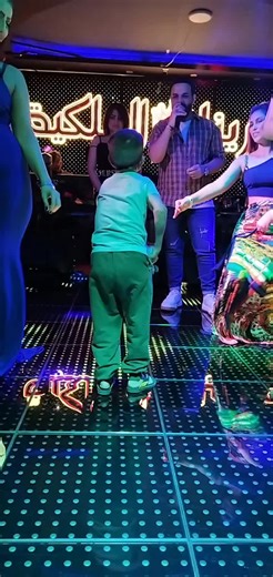 Energetic Dance Moves by a Young Child on Reflective Floor