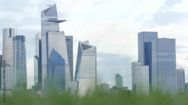 New York City waterfront skyline, Manhattan Midtown Hudson Yards buildings, riverfront skyscrapers. Waterside cityscape from Pier A Park, Hoboken, New Jersey. United States architecture, grass lawn.