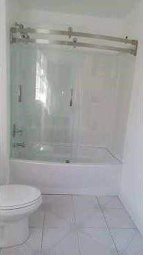 Beautiful Delta Curved Tub and Shower Door installed