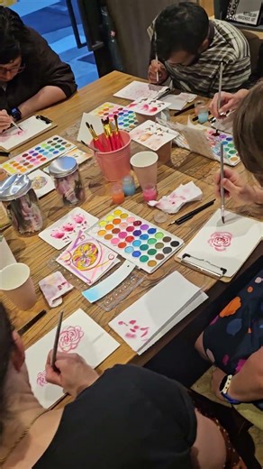 Calming Watercolour Workshops in action, painting roses in a bookshop after dark. So relaxing.