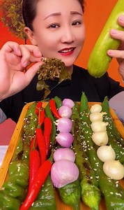 Spicy food show, Eating fried spicy vegetable, fresh red and green chili peppers, onions and garlic | AE Monkey
