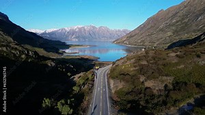 Wanaka, New Zealand: Aerial drone footage of the neck between lake Wanaka and lake Hawea in New Zealand south island. Shot with an upward and tilt down motion