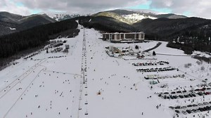 Ski resort and skiers going down the mountain - Free Stock Video