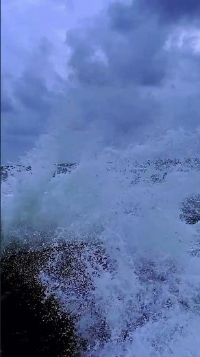 Slow-motion ocean waves crashing on the rocks at night. #viral #shorts #waves #beach