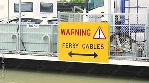 Vehicles on the cable ferry to cross the Murray River. This video shows the ferry in operation and a sign warning of the underwater cables. Stock Video