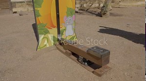 This video shows a test of strength hammer bell carnival game being played close up as the players hammer hits the bottom of the lever.