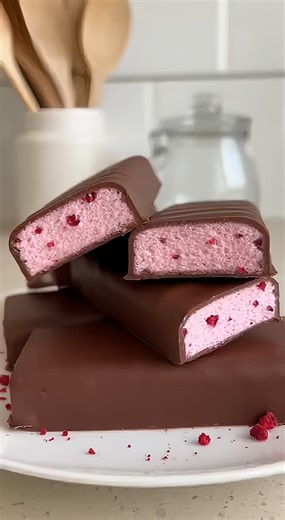 3-Ingredient Raspberry 3 Musketeers Chocolate Bar Homemade Raspberry Marshmallow fluff Bars Ingredients: 16 oz (450g) Marshmallow fluff 2 tbsp (10g) Freeze-dried raspberry powder 12 oz (340g) Milk chocolate chips or chopped melting chocolate Directions: 1. In a large bowl, combine the marshmallow fluff and freeze-dried raspberry powder. Whip until the color is a consistent pastel pink. 2. Line a rectangular pan with parchment paper and spread the pink nougat mixture evenly into the bottom. 3. Pl
