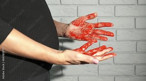 Spontaneous miscarriage. A view of scared woman hands in blood after spontaneous miscarriage.