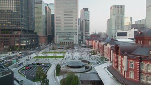 People and cars moving in a city of large buildings - Free Stock Video