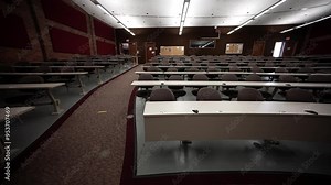 Empty university or college presentation lecture hall with rows of seats for students and speaker. No people.