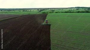 Agriculture. Tractor work on green field. Aerial survey of farm. Farmer in wheat field Tractor work on farm. Landscape of field. Agriculture concept. Farmer work with green wheat. Aerial wheat field