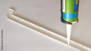 Silicone is applied to the window sill cap for installation. Construction works. Installing a window sill.