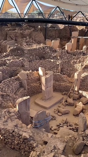 Göbekli Tepe is an archaeological site in the Southeastern Anatolia Region of Turkey. It is an artificial mound with a height of 15 m (49 ft) and a diameter of about 300 m (980 ft). Founded in the 10th millennium BCE and abandoned in the 8th millennium BCE, Göbekli Tepe consists of circles of massive T-shaped stone pillars, making it the world's oldest known megalith. Over 200 pillars in about 20 circles have been identified through geophysical surveys, with each pillar standing up to 6 m (20 ft