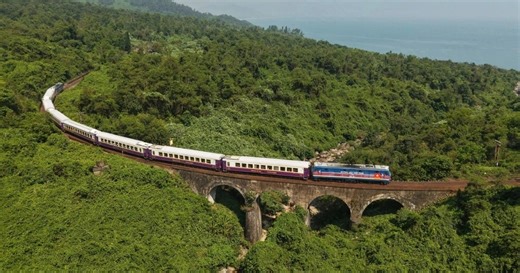 Western tourists wearing traditional Vietnamese ao dai dresses explore the "most beautiful railway line in the world" in Vietnam.