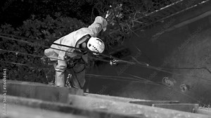 Unrecognisable window cleaner works on high rise building.Window cleaning is considered one of the most dangerous job in the world.Several window cleaners die each year and many are injured Stock Video