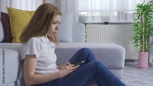 Young woman receiving bad news. Young woman getting bad news on the phone is upset.