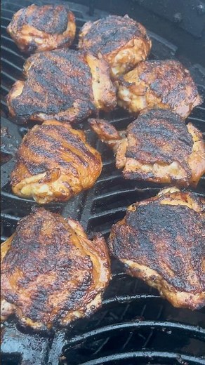 Grilling chicken thighs on a charcoal grill