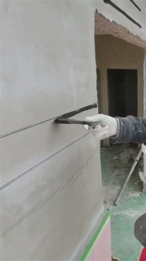 The process of applying lines to a building wall by a craftsman