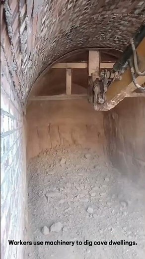 Workers use machinery to dig cave dwellings