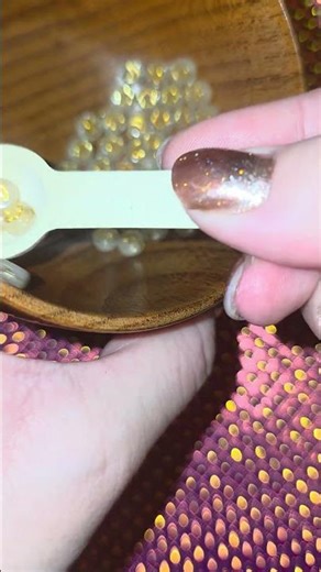 Golden symbols on a fluorescent Beads gently stirred with a bamboo spoon 🪵✨