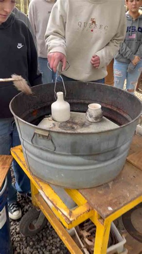 Students create a beautiful look by touching feathers to hot pottery!