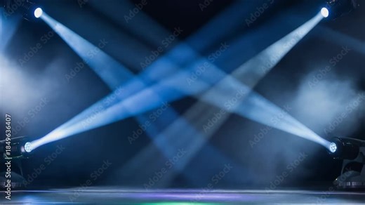 Dynamic stage lighting effects with blue beams and smoke for concerts and performances