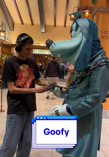 Goofy showing Thomas his chain at Mickey’s Christmas Carol Feast #autism #disneyland #characterdining #mickeyschristmascarolfeast #goofy