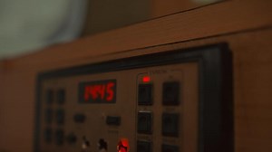 Close-up of a vintage digital clock with red LED numbers, evoking nostalgia and retro technology themes.