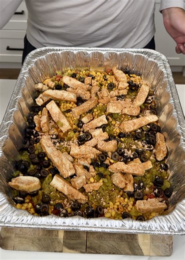 Easy Way To Make A Potluck Appetizer! Danny N shows us how to make an easy appetizer using nacho cheese sauce, black beans, rotel original, mexican style street corn, green chile, black olives, grilled chicken strips, taco seasoning and tortilla chips. | Danny N’s Kitchen