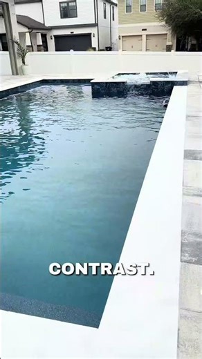 Dark interior pool & spa with white travertine coping. Spacious Sunshelf. Modern Florida Open Yard