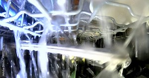 Inside working dishwasher, cleaning dishes with spraying water, GoPro