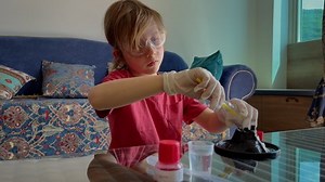 Little boy is doing science experiments at home