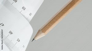 Pencil and paper ruler, rolled up, with centimeter marks, on a white background. Construction theme, slider.