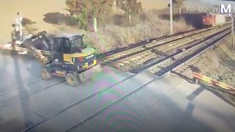 Shocking moment train plows through loader stuck on tracks
