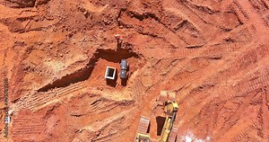 Aerial view of excavator at construction of water main, sanitary sewer, storm drain systems in preparation process on build new house