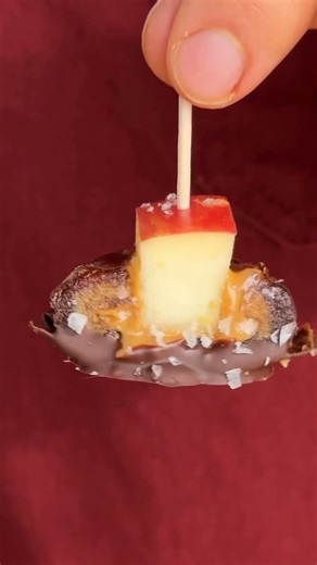 This easy, four-ingredient snack features dates stuffed with peanut butter and apples for a bite that will remind you of a caramel apple. A thin layer of dark chocolate adds the perfect amount of sweetness. Follow the link in the comments to view the recipe—then click the heart icon on the recipe page to save it. 🩷 | EatingWell