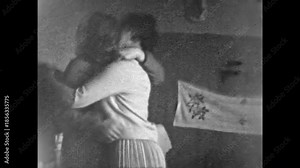Two adult women passionately kissing on lips at home. Happy lesbian love in 1970s. Female couple together in retro romance. Intimate between lgbtq loving in room. Archival old film. Vintage archive