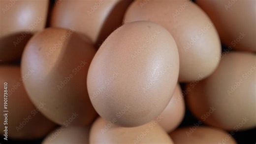 Rotating pile of brown chicken eggs in top view. Smooth shell texture and gentle motion highlight fresh farm food