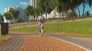 Girl walking through a park on a sunny day - Free Stock Video