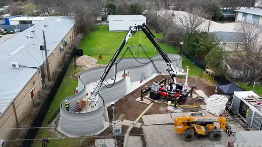 Massive robotic arm 3D prints 27-ft-high two-story house in a first