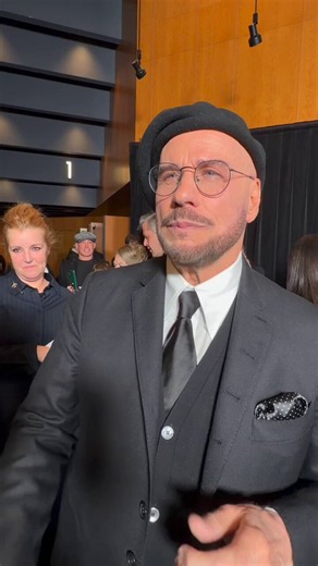 John Travolta reveals he owns 12 berets and explains the reasoning behind the look: "I said, 'You're not an actor unless you're really a director. Why don't you dress like one?' I looked up, to affirm I was correct, all the old-school directors, and they all had berets and sometimes glasses. It was cliché in a wonderful way."
