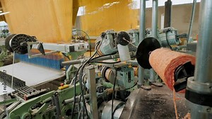 weaving loom. Automated weaving machine is fabricating cloth of threads. weaving factory. textile industry. Textile factory equipment. fabric production.